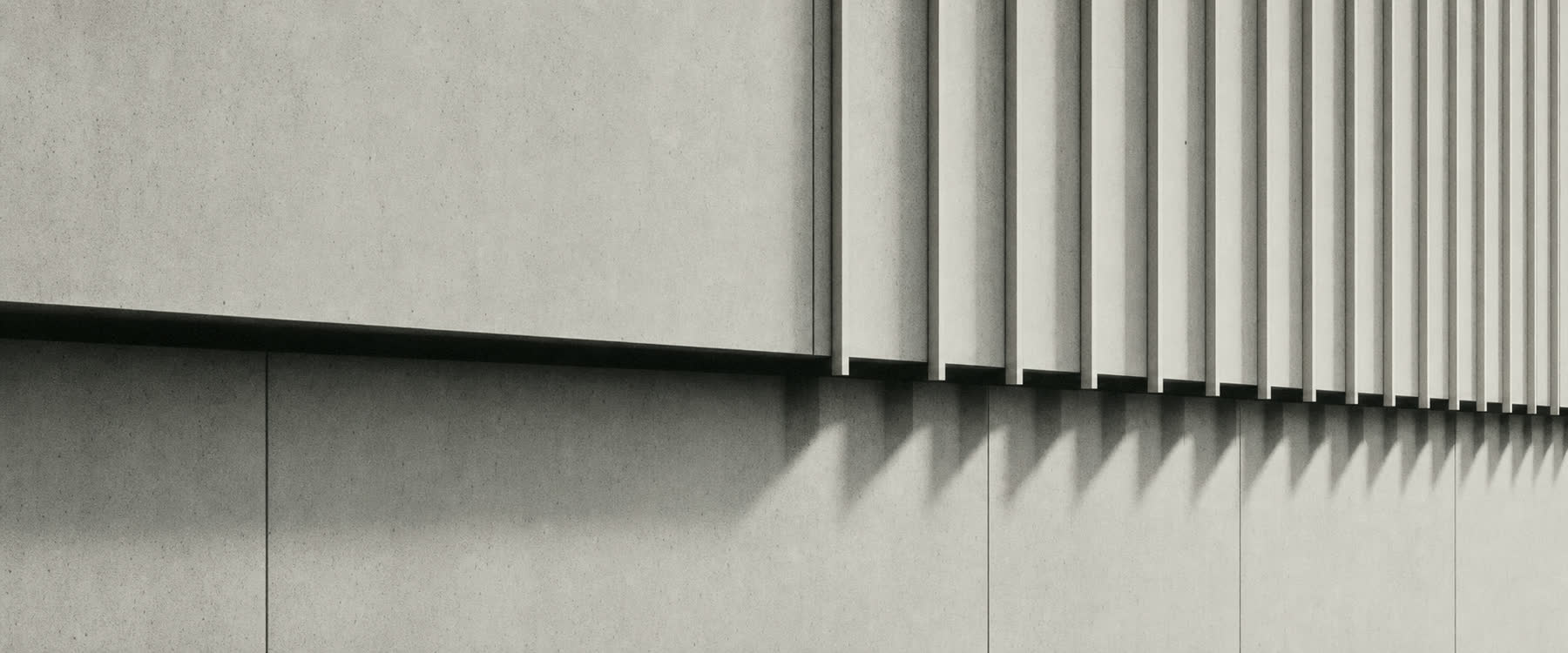 Abstract monochrome architectural detail: rhythmic shadows across a pale concrete facade